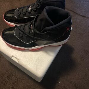 Jordan 11’s.  Black and Red Athletic Shoes